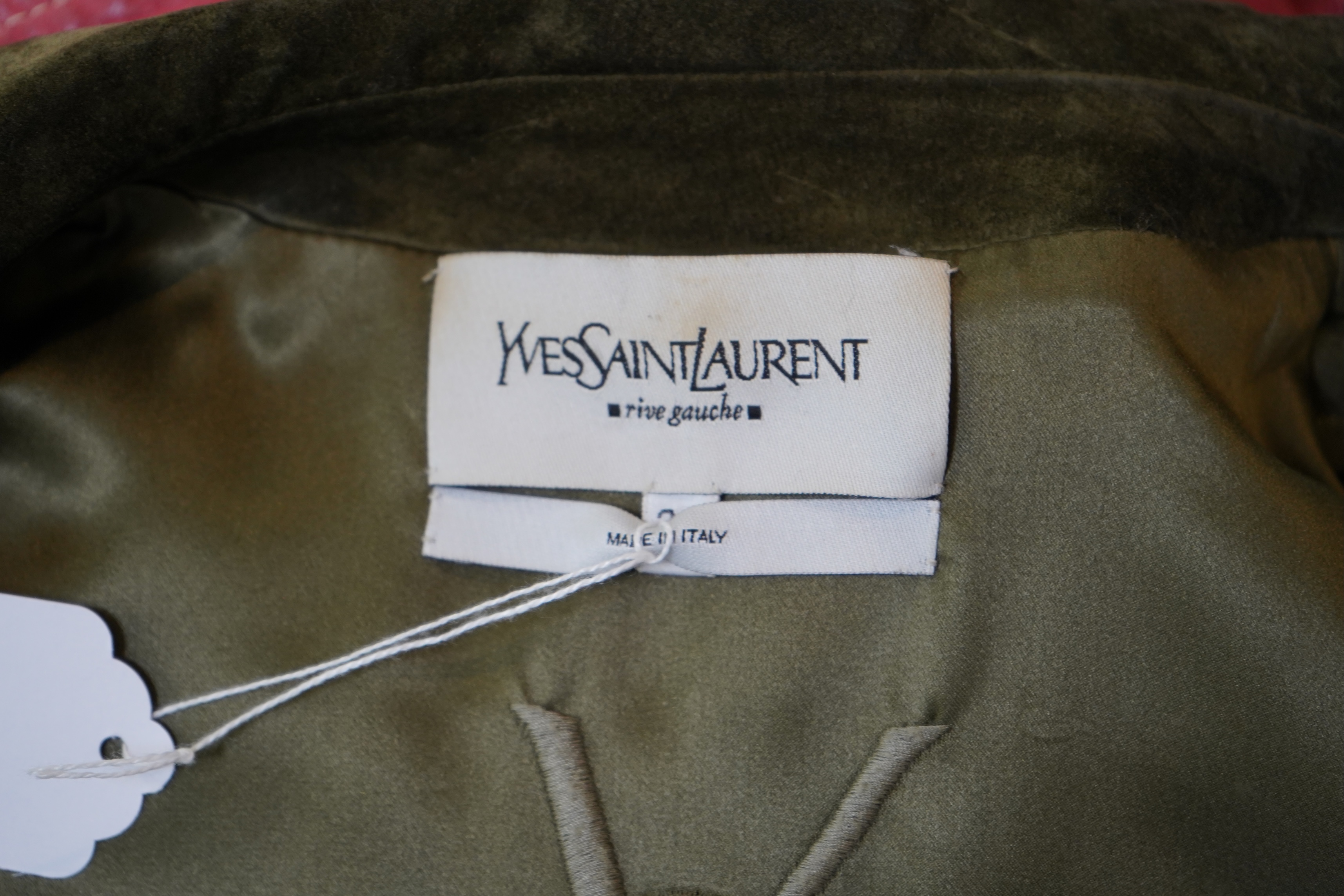 A lady's Yves Saint Laurent olive green suede jacket with stitching details and a black YSL (label missing) gypsy skirt with underskirt. IT 38 (UK size 10)